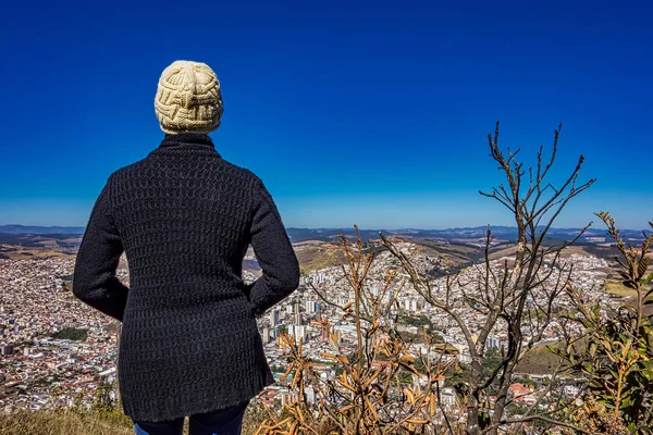 Fotoğrafta dağın tepesindeki kadın Pocos de Caldas - Minas Gerais / Brazil - aşağıdaki şehri izliyor.. 