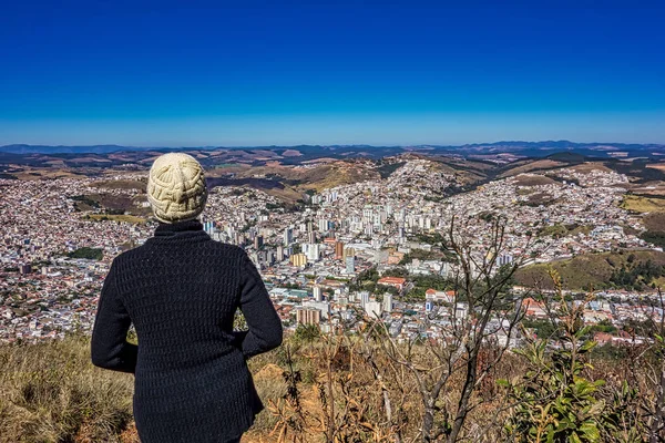 Fotoğrafta dağın tepesindeki kadın Pocos de Caldas - Minas Gerais / Brazil - aşağıdaki şehri izliyor.. 