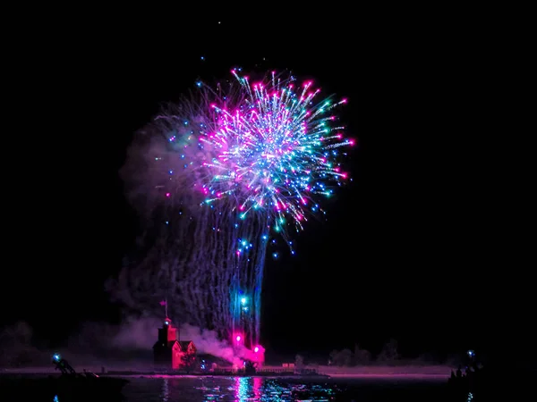 Big Red lighthouse in Holland Michigan with 4th of July fireworks display