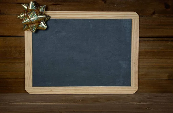 Gold Christmas Bow Blank Black Chalkboard Rustic Wood — Stock Photo, Image