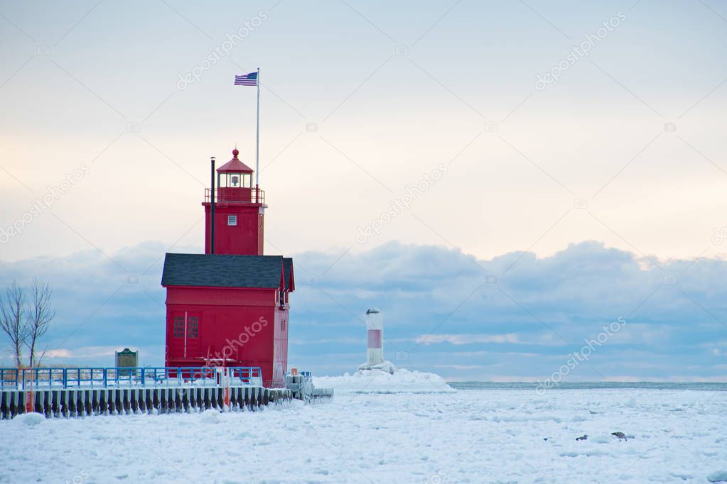 Big Red lighthouse in Holland Harbor channel in winter