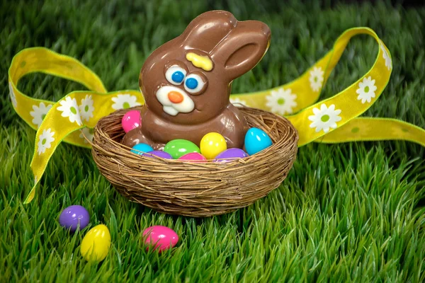 Chocolate Easter Bunny Nest Colorful Eggs Green Grass Yellow Ribbon — Stock Photo, Image