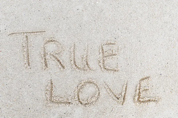 true love text written in beach sand