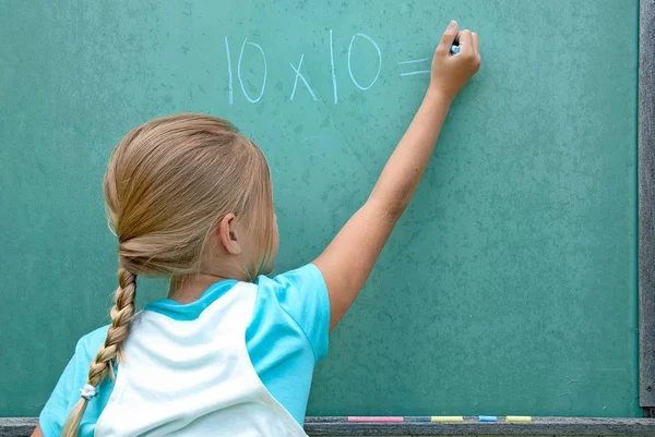 Young Caucasian Girl Writing Math Problem Green Chalkboard — Stock Photo, Image