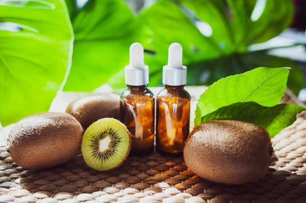 Bottles Kiwi Oil Fresh Fruit Whole Half Natural Tropical Background — Stock Photo, Image