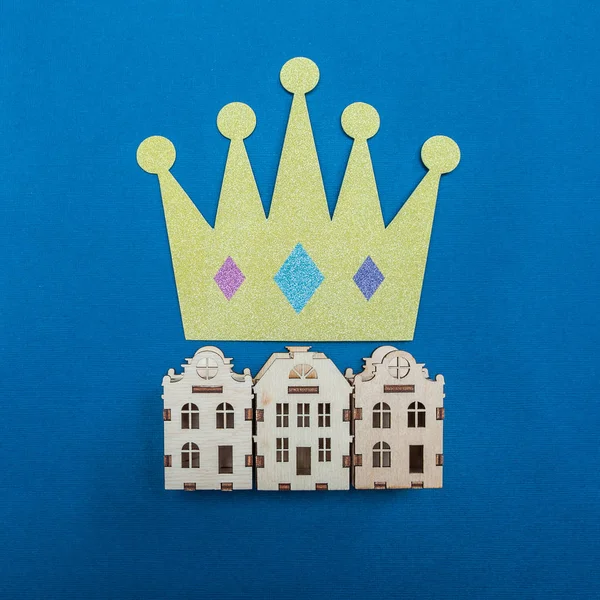 Kingdom logo. Houses and the crown above them, the symbol of the kingdom. Minimalism, View from above, flat lay