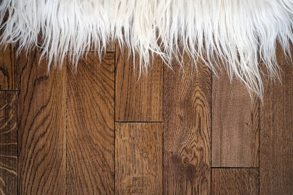 Decorative fur carpet on wood floor — Stock Photo, Image