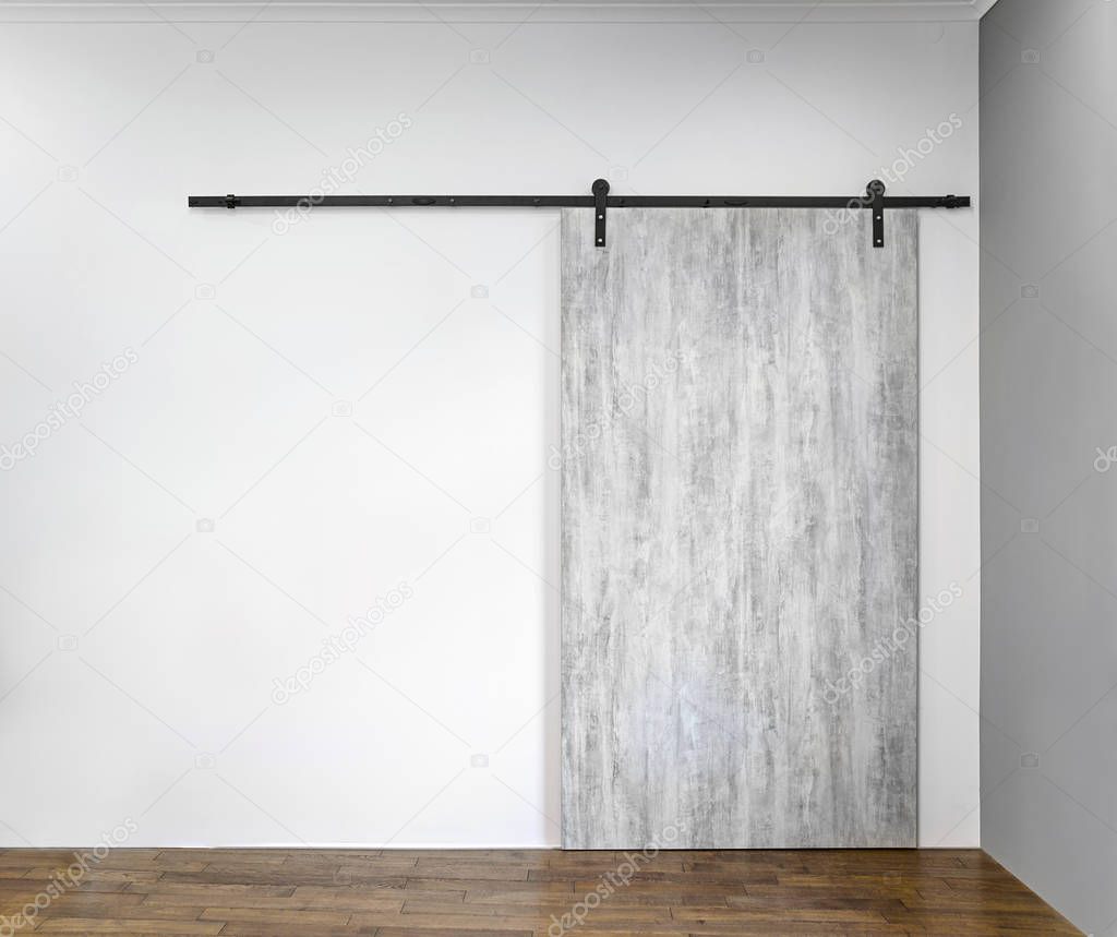 Modern sliding gray door on white wall