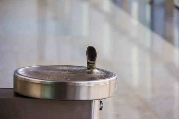 drinking water fountain outlet in airport with water cooler and steep tap and steel sink basin