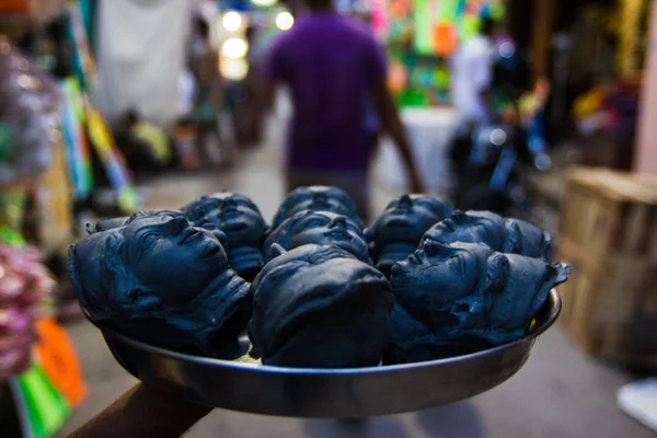 Kumartuli, Batı Bengal, Hindistan, Temmuz 2018, bir esnaf Kumartuli, Kalküta, Hindistan, bir tabak üzerinde tanrıça Durga başkanları taze yapılmış ve boyalı kil taşır. Durga puja Doğu Hindistan ve dünya çapında en çok beklenen hindu Festivali olduğunu.