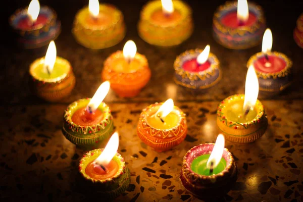 earthen diya lamp lighting with candles on the occasion of diwali and sandhi pujo