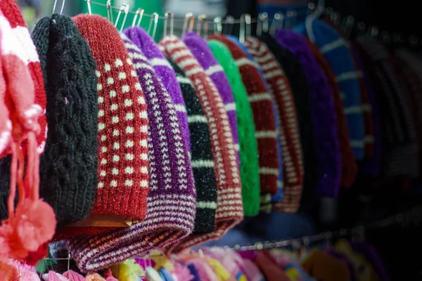 colourful woolen caps for sale at a garment shop. Winter shopping season