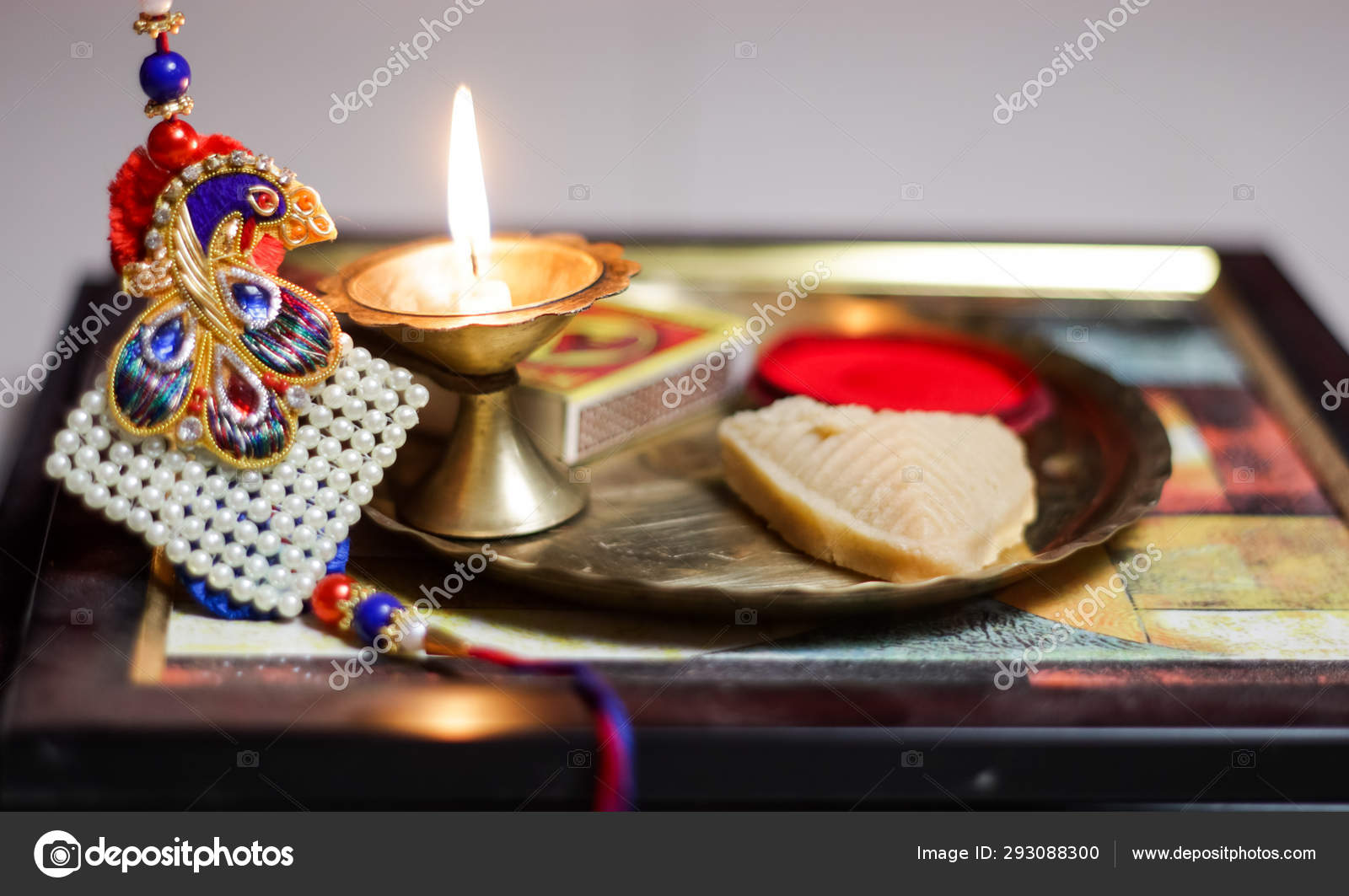A Plate Thali Decorated With Rakhi Sweet Lamp Diya For The