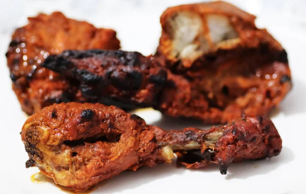 Chicken tandoori leg piece, an indian punjabi spicy preparation in white background with selective focus on foreground — Stock Photo, Image