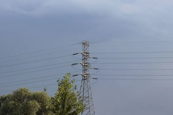 High Voltage Power Line Illuminated Sunlight Background Clouds Stormy Sky — Stock Photo, Image