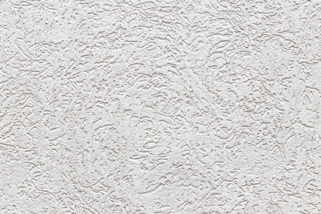 Texture of a fragment of a wall of a modern structure of white color. Harshness in the style of bark beetle.A background for design and creative work. Decoration and exterior decoration of the build