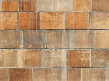 Duvar yumuşak cilalı taş döşeme kumtaşı yaptı. Doku duvar eski bir yapısının bir parçası. Tasarım ve yaratıcı çalışma için bir arka plan. Dekorasyon ve dış dekorasyon