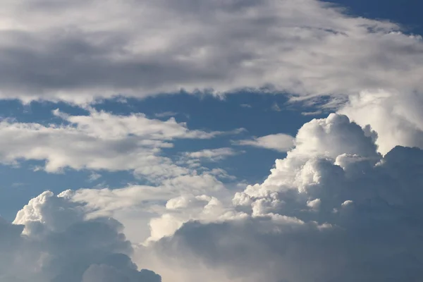 Clear blue sky with cumulus and cirrus clouds. Sunny weather. Joyful mood. High pressure. Clean air ecology. Water in a gaseous state. The source of rain and hail. Weather prediction.