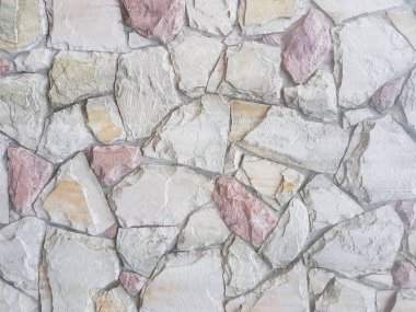 Antik Ortaçağ taş duvar. Doku duvar eski bir yapısının bir parçası. Tasarım ve yaratıcı çalışma için bir arka plan. Bina dış cephe süsleme ve dekorasyon. İnşaat işleri.