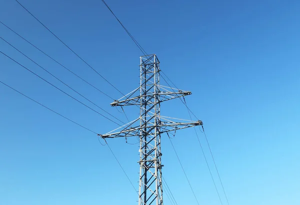 Electrical network of high voltage. Transportation of electricity through the high-voltage line. Metal tower with wires and cables. Clean country energy. Energy security. Work at height. Training matt