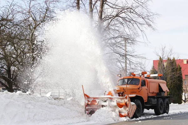 一辆有犁的大车把道路从雪中清理干净 橙色货物专用设备在冬季与元素作斗争 消除雪灾的影响 交通困难 冷冻水 — 图库照片