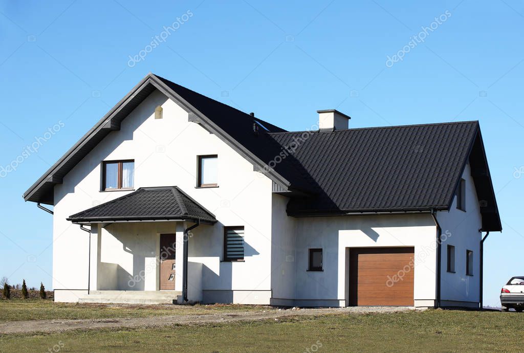 Jaslo, Poland - 9 2 2019: The project of a modern villa. Project of a small villa with clear walls and a brown roof. Rear and front courtyard of a private territory. Mastering new land and building.