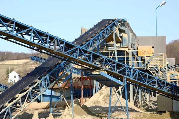 Elementos do equipamento para a extração e triagem de entulho. Produção de materiais de construção. Construção de metal para trabalhar com pedra e pedras. Escória de cascalho sob a correia transportadora — Fotografia de Stock