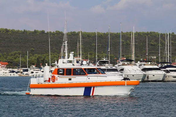 Bateau pilote navigue dans les eaux de la marina parmi les yachts à voile amarrés. Assistance à l'amarrage du navire dans le port maritime. Garde-côtes et inspection des navires arrivés. Charte méditerranéenne à Croati — Photo