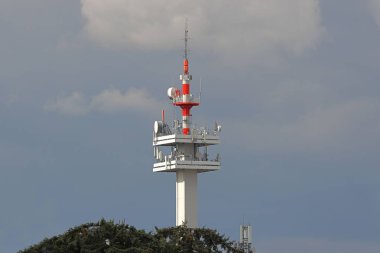 Radio tower with antennas on a blue sky background. Metal construction. Wireless network. Transmit tv radio signal. Egology of the environment. Information digitalization and high technology