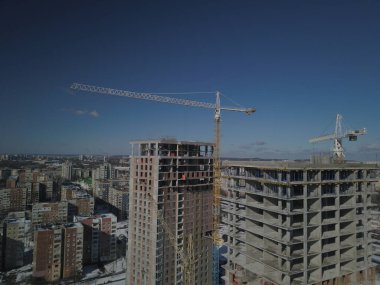 Lviv, Sychiv, Ukrayna - 272020: Kule vinçleri çok katlı bir binanın yapımı sırasında çalışır. Apartman sakinleri için yeni daireler ve ofisler için binalar. Yüksekken riskli iş. Ağır yapı kaldırılıyor