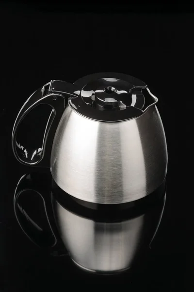 Coffee pot with black lid on the black mirror background. — Stock Photo, Image