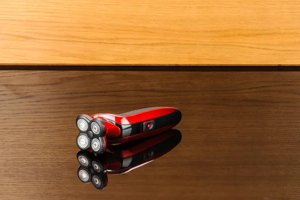 Electrical red shaver, haircut isolated on the wood mirror backg — Stock Photo, Image