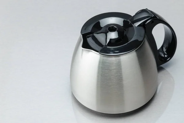 Coffee pot with black lid on the grey mirror background. Copy sp — Stock Photo, Image