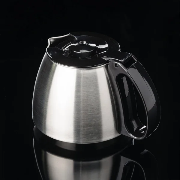 Coffee pot with black lid on the black mirror background. — Stock Photo, Image