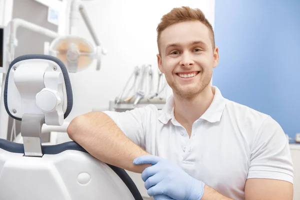 Qualified dentist. Handsome male dentist smiling confidently to the camera posing at his office copyspace teeth dentistry professionalism occupation qualification experience medical happiness concept