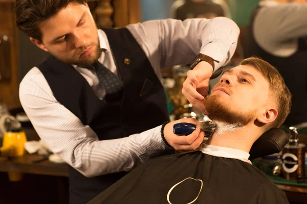 Handsome Young Bearded Man Being Shaved Professional Barber Barbershop Applying — Stock Photo, Image