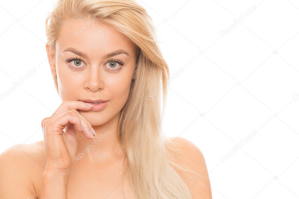 Close up studio portrait of a stunning beautiful young blonde woman posing seductively  with her finger to her lips isolated on white cosmetology treatment spa facial care flawless perfection unblemished 