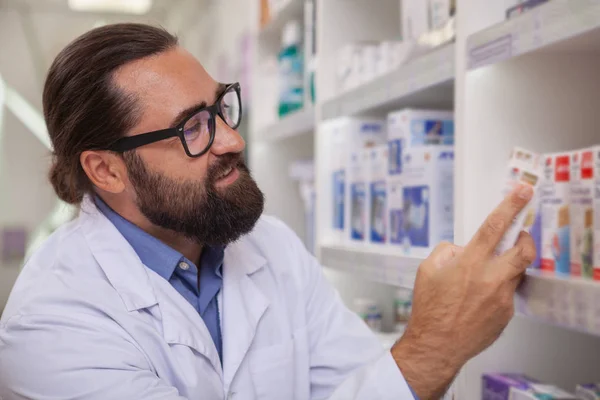Bearded Mature Pharmacist Examining Pack Vitamins Sale His Drugstore Copy — Stock Photo, Image