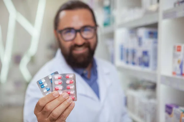 Selective Focus Colorful Pills Blisters Cheerful Bearded Pharmacist Holding Copy — Stock Photo, Image