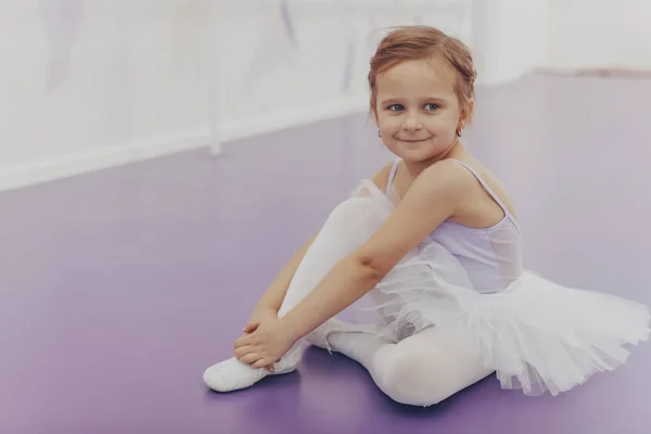 Adorable little ballerina in a ballet studio