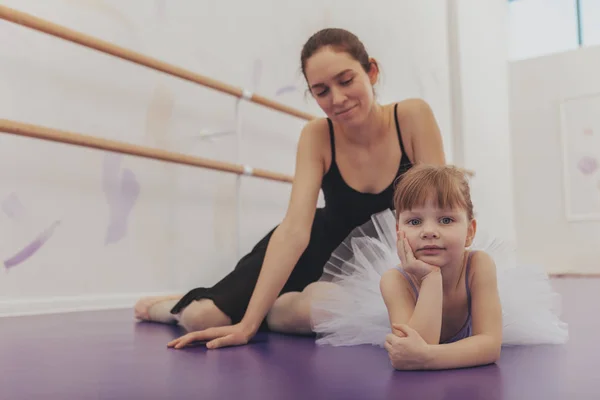 Professional ballerina teaching ballet to her young students