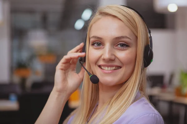 Friendly customer support operator with headset working at call — Stok fotoğraf