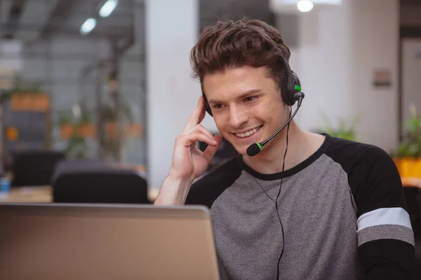 Friendly customer support operator with headset working at call 