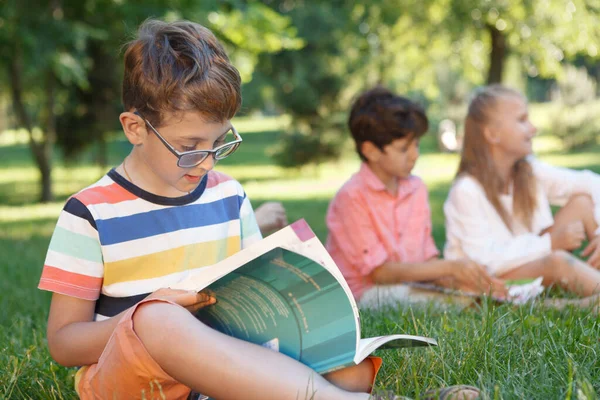 Cute Little Boy Studying Outdoors His Friends Background — Stock Photo, Image
