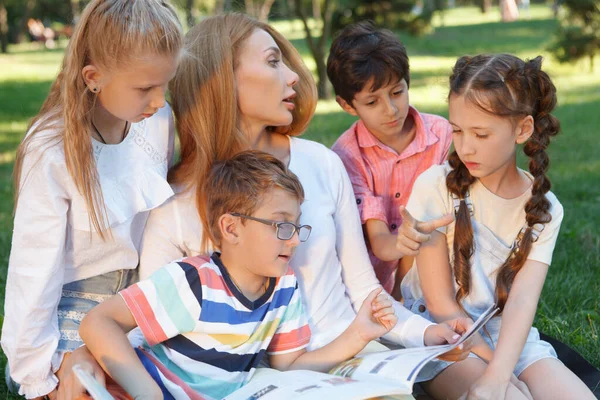 Young Attractive Female Teacher Reading Book Her Little Students — Stock Photo, Image