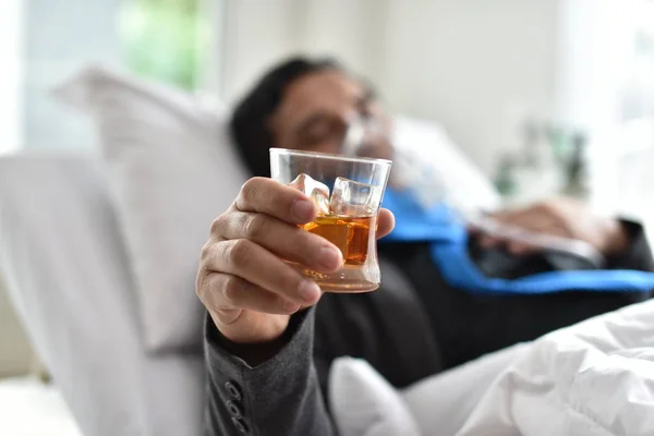 Drinking alcohol is great for health. Businessmen with alcohol Drink heavily until hospital bed.