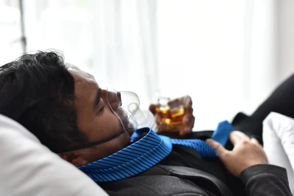 Drinking alcohol is great for health. Businessmen with alcohol Drink heavily until hospital bed.