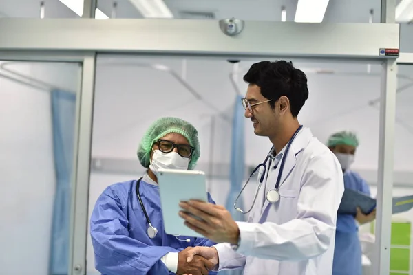 Photos of doctors in work uniforms Doctor consulted about the patient's case in the emergency room.