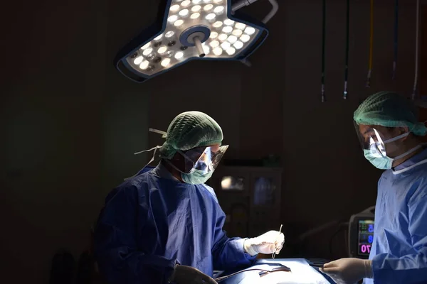 Medical Team Performing Surgical Operation in Modern Operating Room. Equipment and medical devices in hybrid operating room.scrub nurse preparing medical instruments for operation.