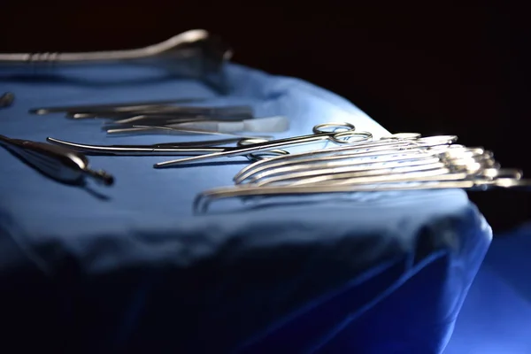 Team surgeon at work in operating room. Surgical light in the operating room. Preparation for the beginning of surgical operation with a cut. The surgeon is performing surgery on the patient.